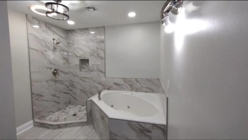 Completed corner bath with marble tiled surround