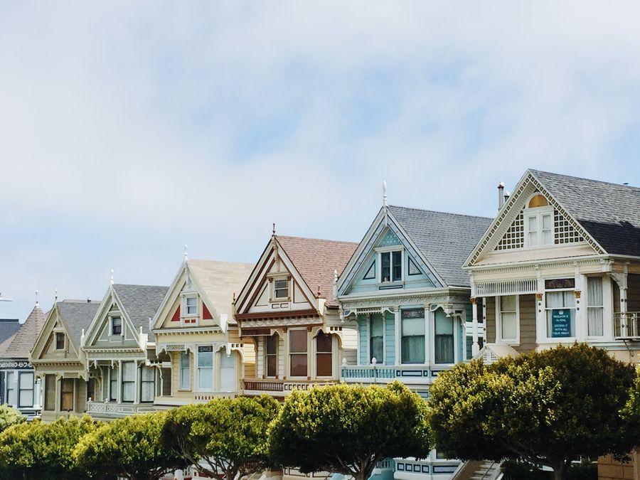 Row of historic timber houses with decorative railings and balconies