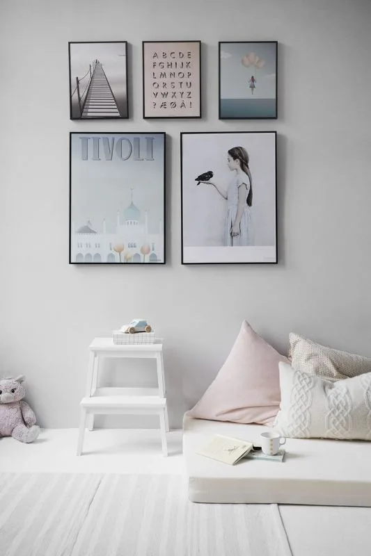 Bedroom wall with framed art and a bedside table